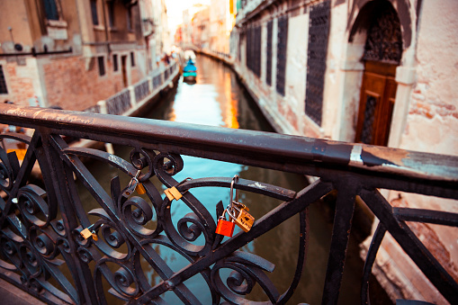 Bridge with love locks over the Venice water canal, Italy