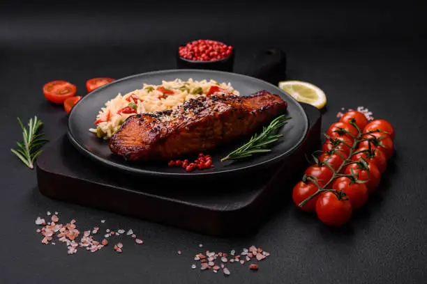 Photo of Delicious red salmon fish grilled with sauce and sesame seeds with rice and vegetables