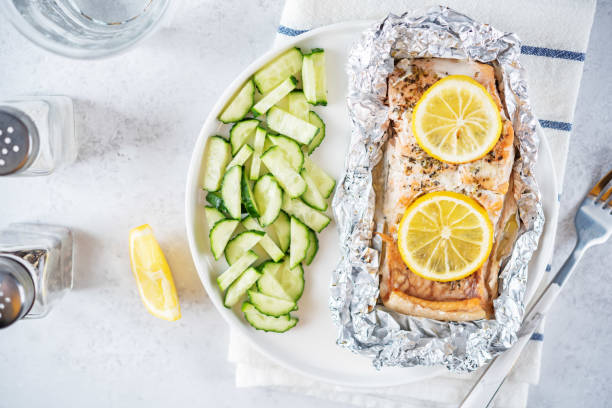 istock Salmon with herbs and lemon slices baked in a foil 1483370218
