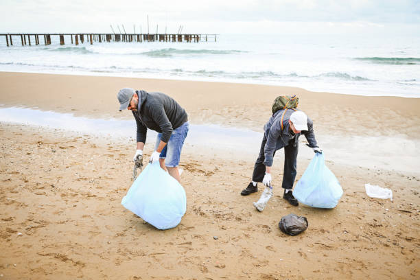 istock father and son cleans up the beach 1483372545