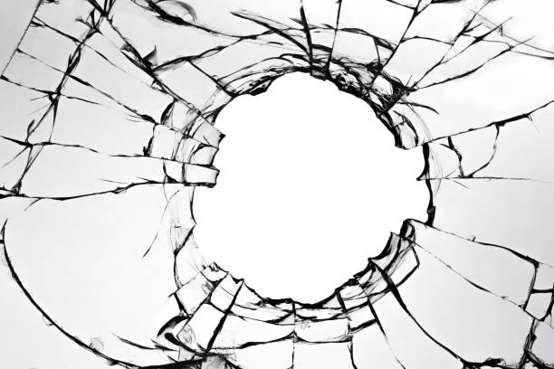 istock Cracked broken glass on a white background. Damaged window texture with a hole. 1483373663