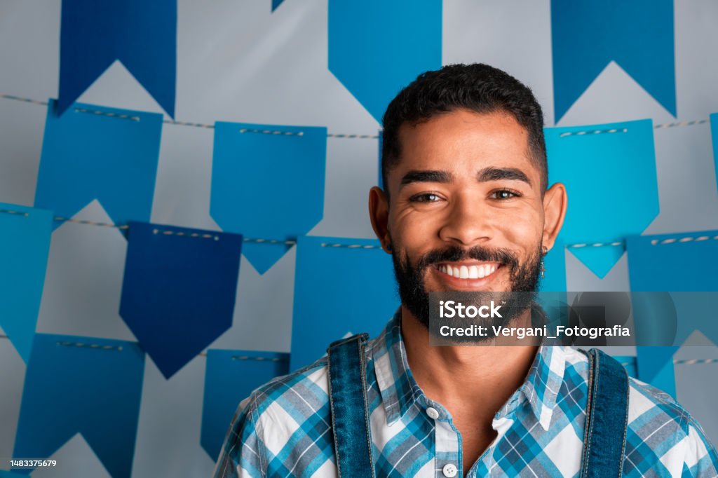 Festa Junina: party in Brazil, portrait of brazilian man smiling at traditional festival in caipira clothes Festa Junina Stock Photo