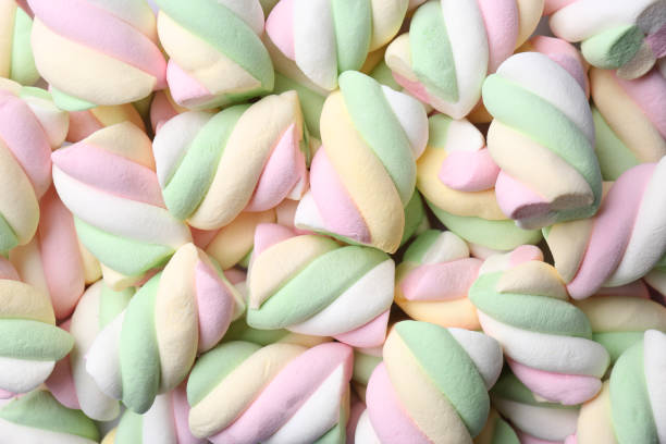 istock Delicious colorful marshmallows as background, top view 1483376660