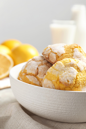 Delicious lemon cookies in bowl on table, closeup