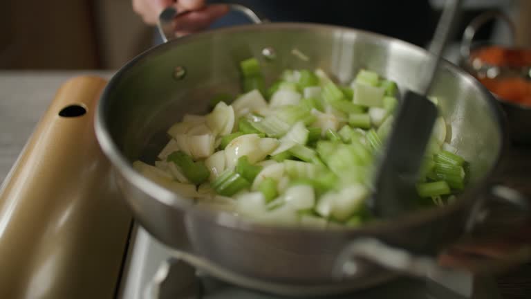 frying onion, celery together for making beef stew