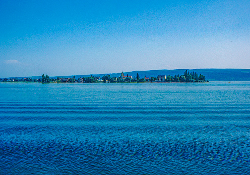 1989 old Positive Film scanned, the view of Lake Constance, Island Reichenau,  Germany.\nSt. Georg Church Sankt Georg, Lake Untersee,Konstanz