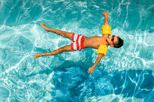 istock Boy restin floating in the swimming pool 1483381642