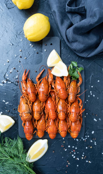 istock cooked crawfish on platter with lemons and spices on dark background 1483387298
