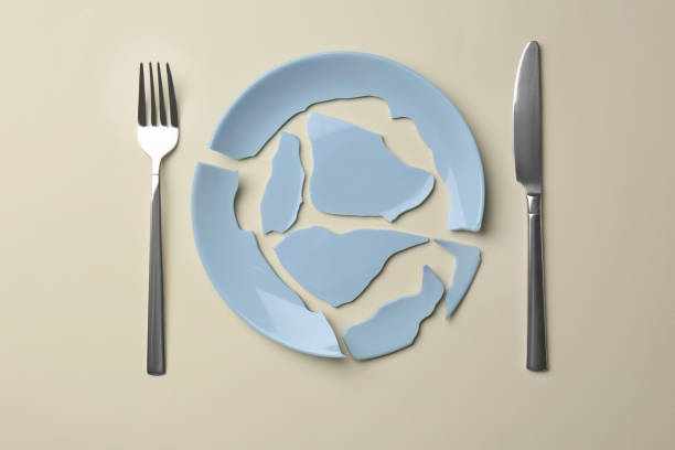 istock Pieces of broken ceramic plate and cutlery on beige background, flat lay 1483390136