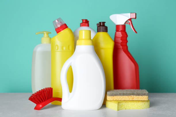 istock Different cleaning supplies and tools on table against turquoise background 1483390779