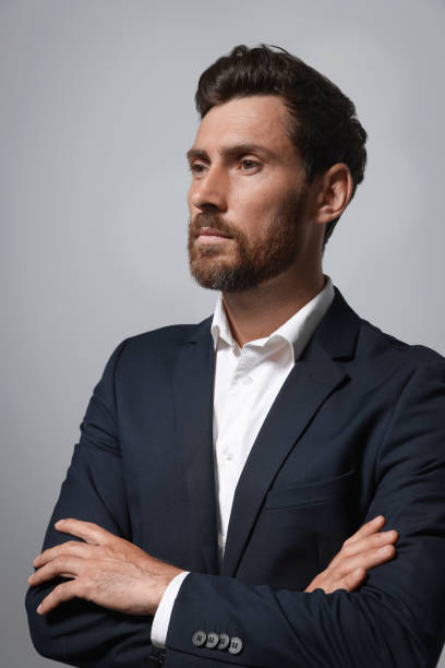 istock Handsome bearded man in suit on light grey background 1483392743