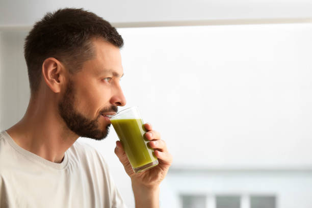 istock Man drinking delicious juice indoors, space for text 1483392776