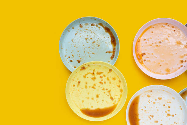 istock Dirty dishes on yellow background. Top view 1483401153