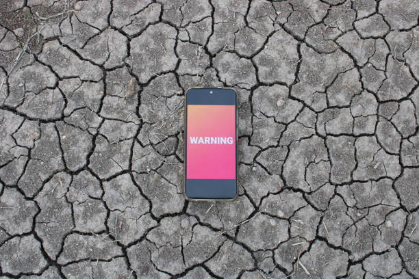 A woman's hands touch the screen on a smartphone. The screen is blank, offering copy space for your message. The background is out-of-focus texture.