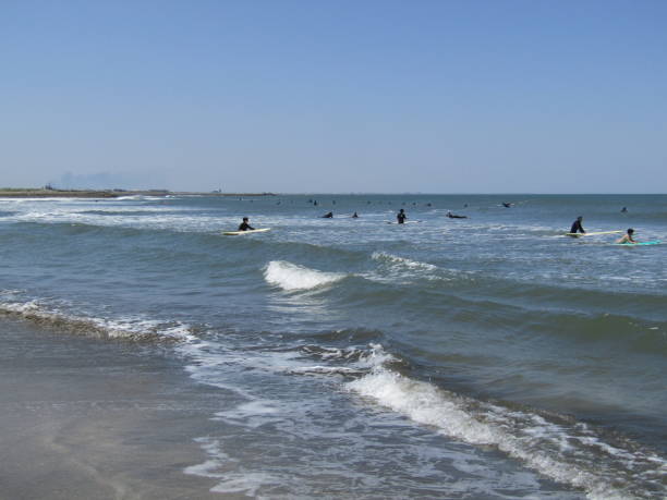 Japan. Nice sunny day in May. Surfers.