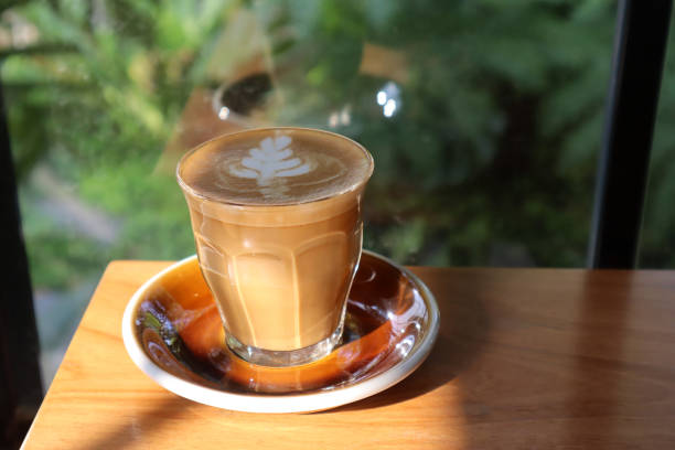 istock Flat white coffee in crystal glass on wooden table. 1483405134