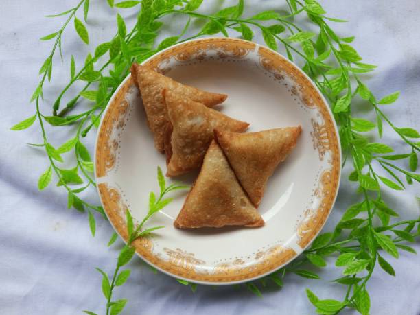 Indonesian Vegetable sambusa with meat fish filling on a mini plate with plastic grass