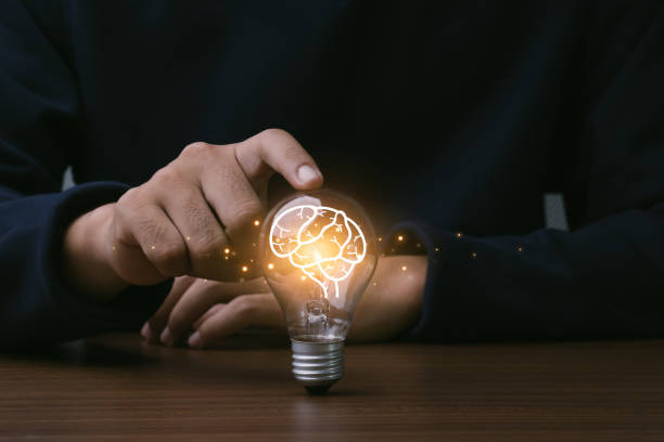 istock Creative thinking idea for Technology concept.Hand of man touching light bulb with orange glowing and brain icon.Idea concept. 1483406839