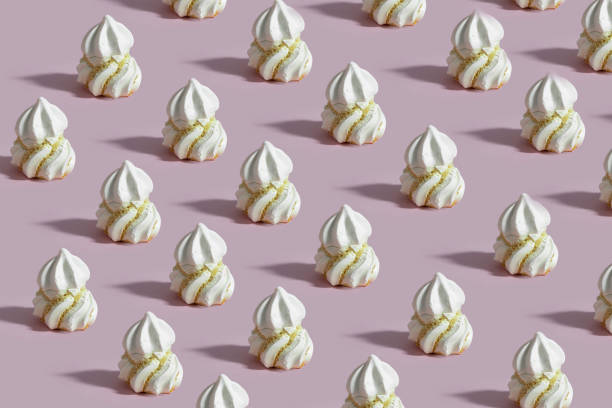 istock French Meringue  dessert pattern on pink background. 1483411597