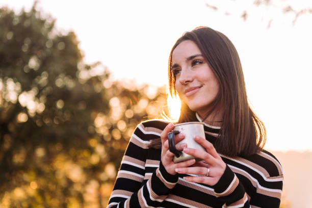 istock woman embraces the outdoors finding peace with tea 1483411929