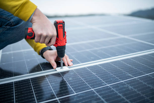 istock Close up of worker using drill ro repair solar panels. 1483412477