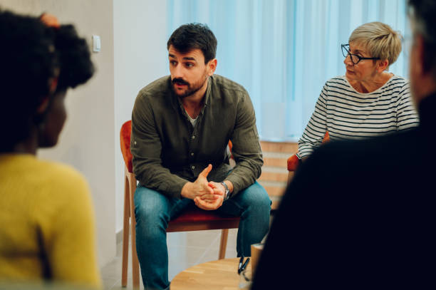 istock Young man talking about his mental health on a group therapy session 1483412925
