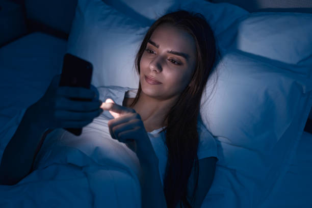 istock Sleepy woman browsing smartphone in bed 1483416990