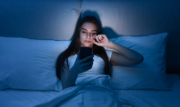 istock Woman browsing smartphone in bed at night 1483417006