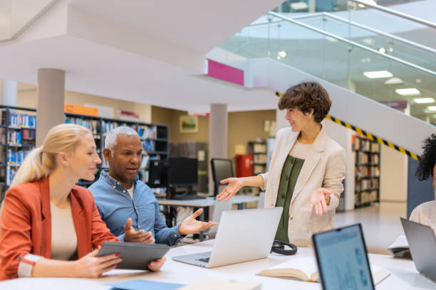 istock Readers and students in the library 1483417158