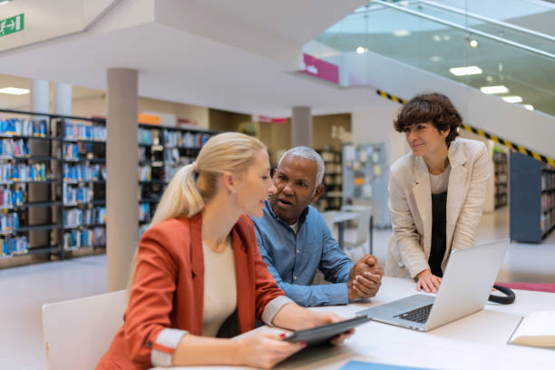 istock Readers and students in the library 1483417161
