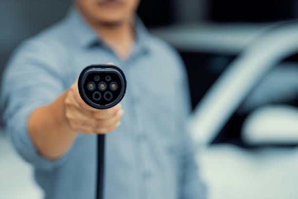 istock Focus progressive EV charger device pointing at camera with blur background. 1483417459