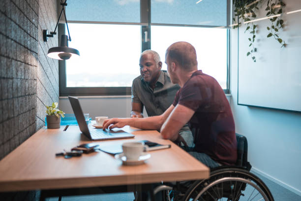 istock White Young Intern Using Laptop to Explain Project to Latin CEO 1483417658
