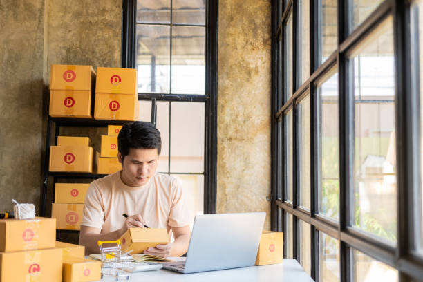 istock Asian man taking customer orders online with laptop, online business and e-commerce online store. sell home goods 1483421532