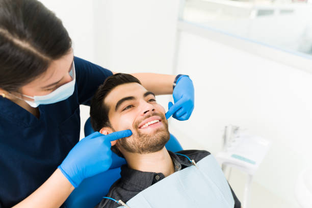 istock Attractive young man with a big smile at the dentist 1483421766