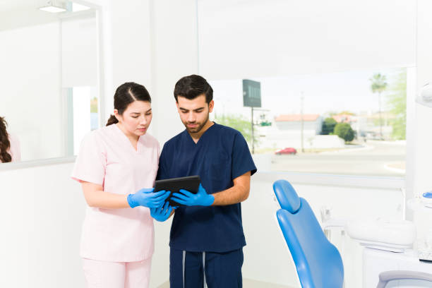 istock Caucasian dentist and latin dental assistant ready for a patient 1483421880