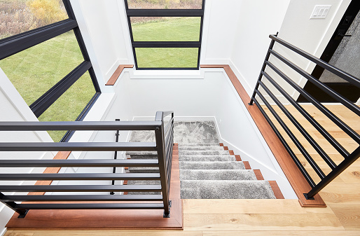 A detail of staircase with carpet in living room