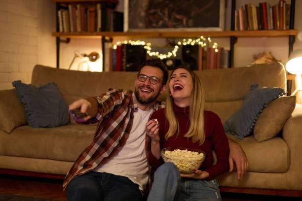 istock Young romantic couple watching TV at home 1483430522