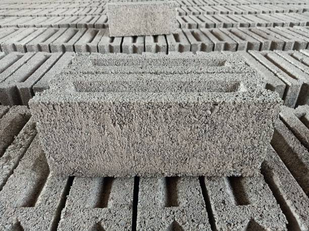 istock Concrete Bricks drying outdoors in line. Brick production on a home factory 1483435903