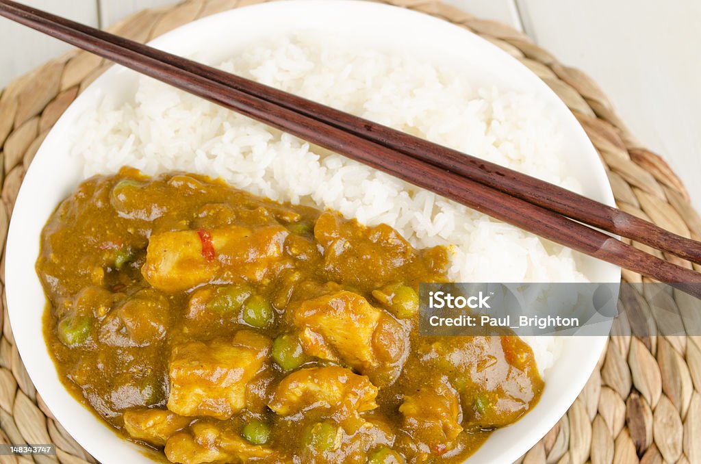Chinese Chicken Curry &amp; Steamed Rice Chinese chicken curry with peas served with white rice in a bowl Curry - Meal Stock Photo