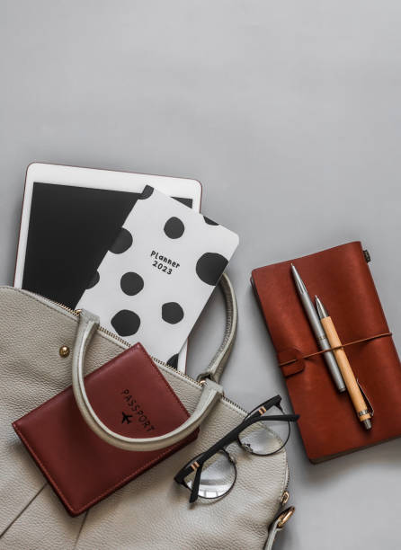 istock Office women's business education background. Women's bag, tablet, planner, notepad on a gray background, top view 1483451125