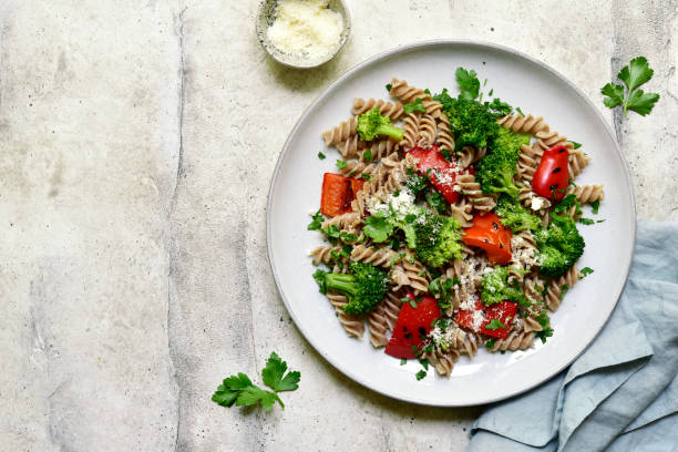 istock whole grain pasta fusilli with grilled bell pepper and broccoli. Top view with copy space. 1483456313