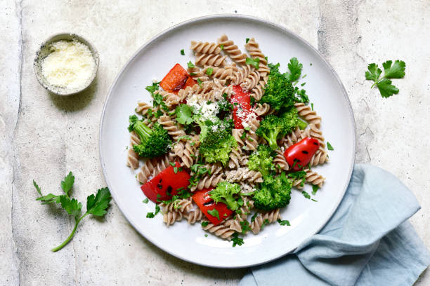 istock whole grain pasta fusilli with grilled bell pepper and broccoli. Top view with copy space. 1483456339