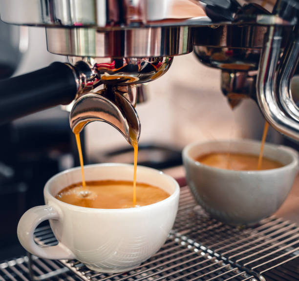 istock Espresso coffee extraction from a professional coffee machine with a bottomless filter, Close-up of a coffee drop  from the coffee machine 1483463071