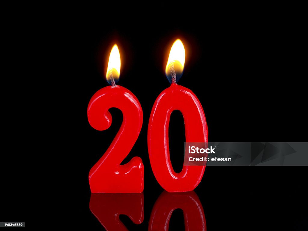 Anniversary-birthday  candles. Nr. 20 Anniversary candles with red numbers and isolated on black  background Anniversary Stock Photo