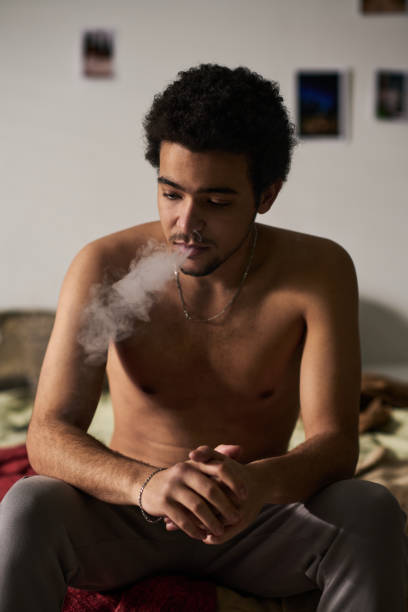 istock Depressed man smoking in the room 1483466414