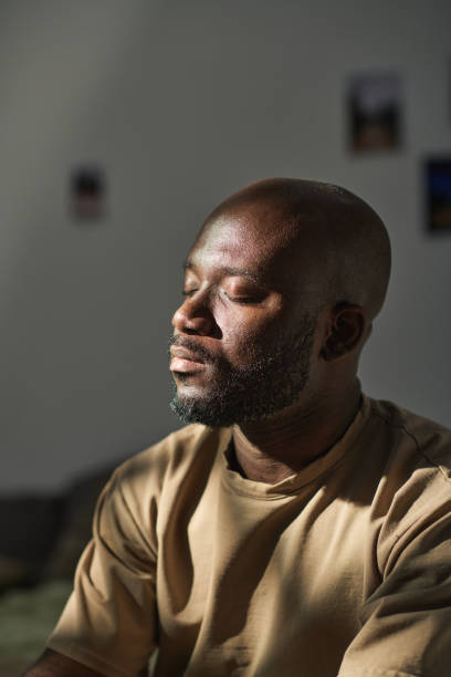 istock African American man meditating at home 1483466546