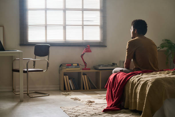 istock Man sitting alone in his bedroom 1483466570