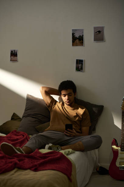 istock Teeange boy reading message on smartphone 1483466666