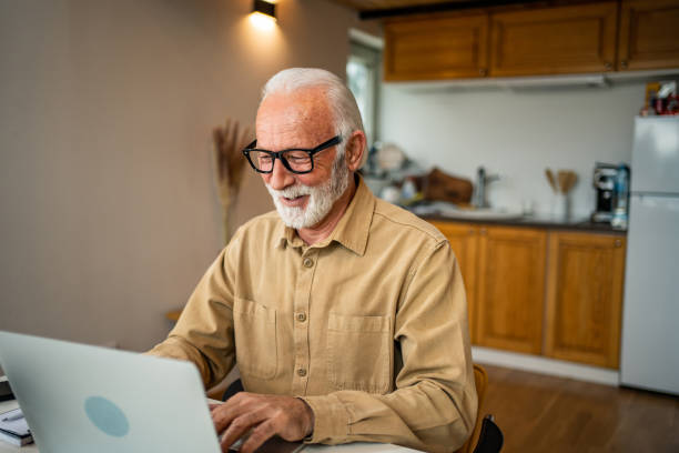 istock An elderly man, a pensioner, learns online, he spends his retirement days studying online, thus continuing his activities and still perfecting his skills. 1483466732