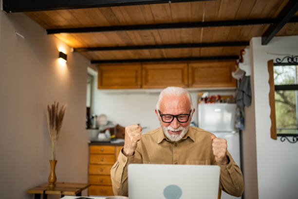 istock An elderly man, a pensioner, learns online, he spends his retirement days studying online, thus continuing his activities and still perfecting his skills. 1483466816